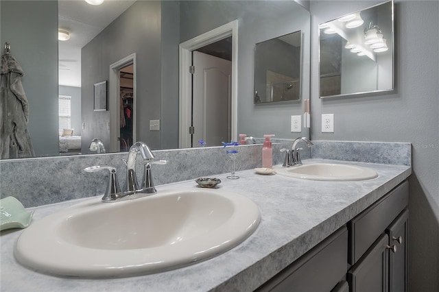 bathroom with a sink and double vanity