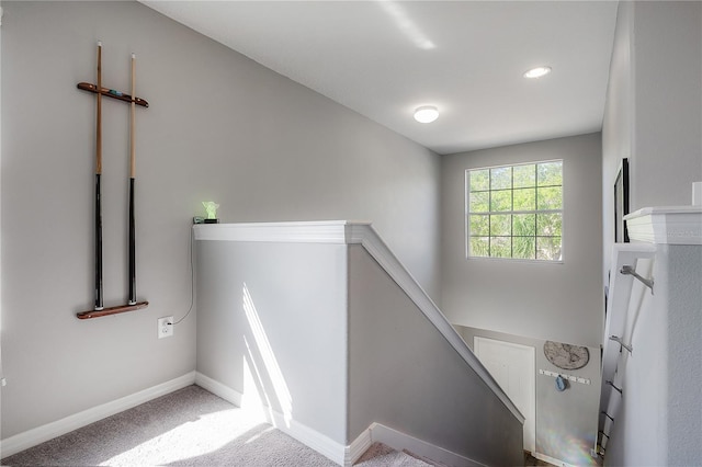 stairs featuring baseboards and carpet floors