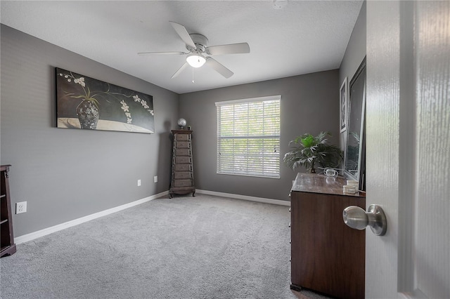 interior space featuring a ceiling fan and baseboards