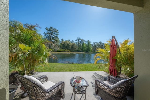 view of patio with a water view