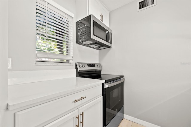 kitchen featuring baseboards, visible vents, light countertops, appliances with stainless steel finishes, and white cabinetry