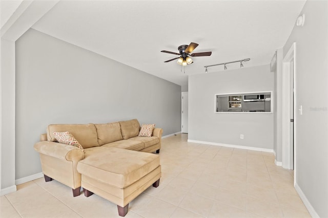 living area with rail lighting, baseboards, a ceiling fan, and light tile patterned floors