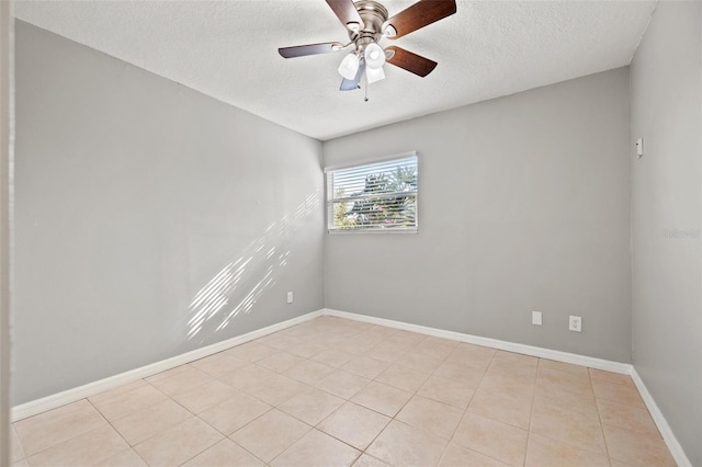 unfurnished room with light tile patterned floors, a textured ceiling, baseboards, and ceiling fan