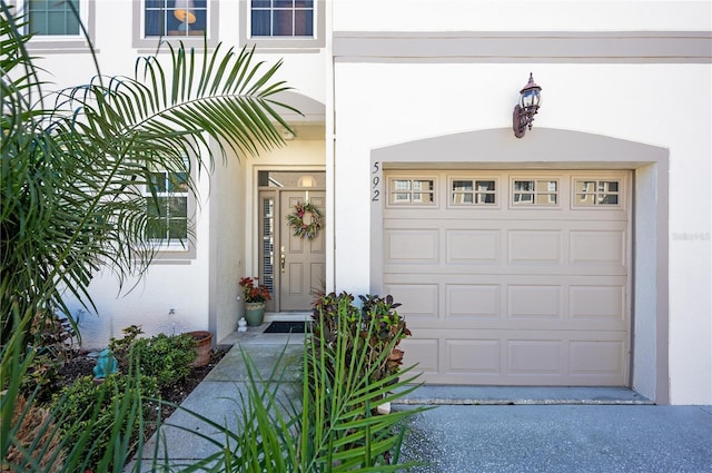 view of exterior entry featuring stucco siding