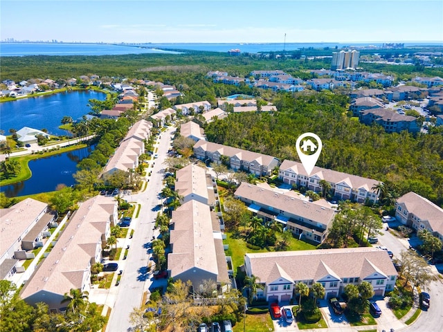 birds eye view of property featuring a water view and a residential view