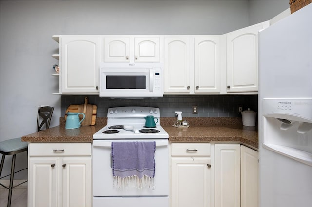 kitchen featuring white appliances, tasteful backsplash, dark countertops, and white cabinetry