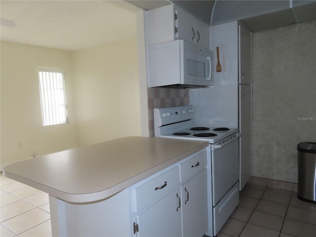 kitchen featuring light countertops, decorative backsplash, light tile patterned flooring, white cabinets, and white appliances