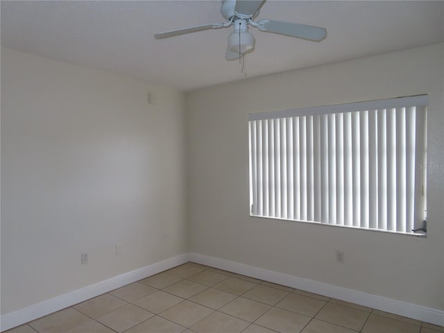 unfurnished room featuring a wealth of natural light, baseboards, and a ceiling fan