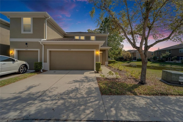 view of front of house with driveway and stucco siding