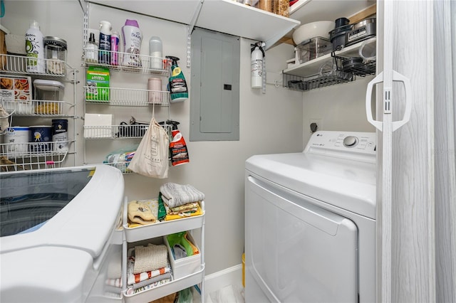 washroom featuring electric panel, separate washer and dryer, and laundry area