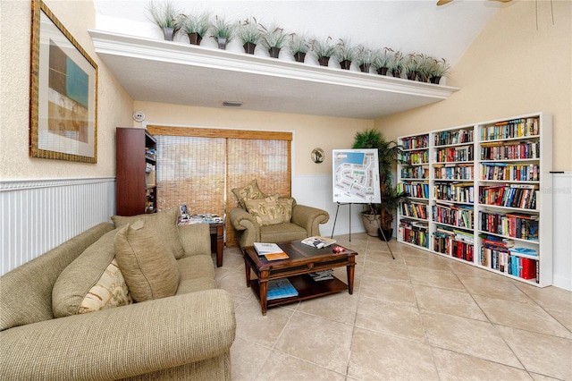 tiled living area featuring visible vents and wainscoting