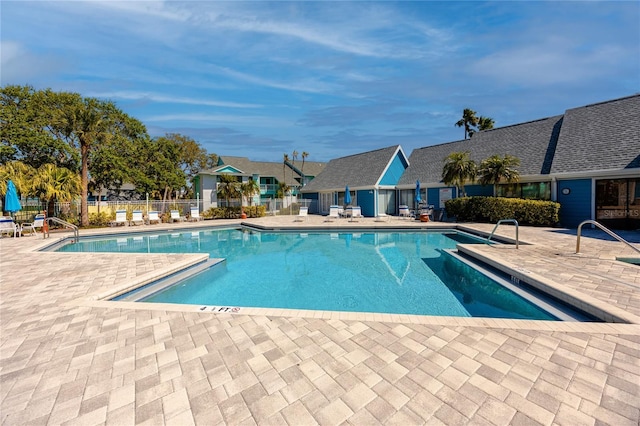 community pool featuring a patio area and fence