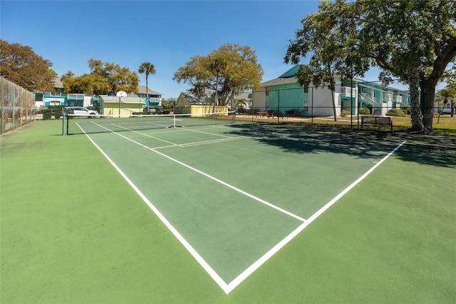 view of tennis court featuring fence