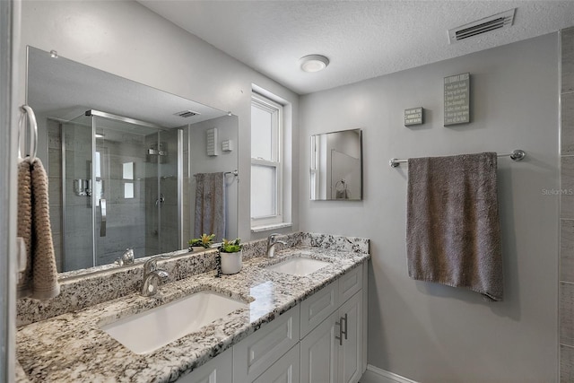 full bath featuring a sink, visible vents, and a stall shower