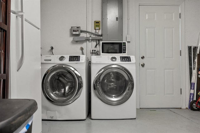 washroom with laundry area, electric panel, and washing machine and dryer