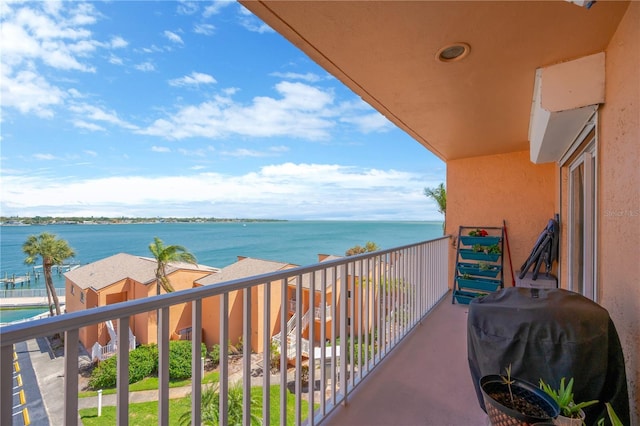 balcony with a water view and area for grilling