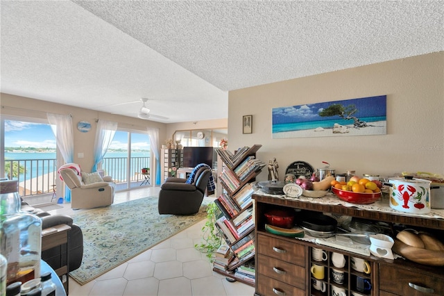 tiled living room with a textured ceiling and ceiling fan