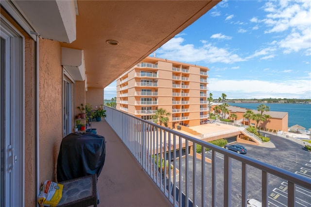 balcony featuring area for grilling and a water view