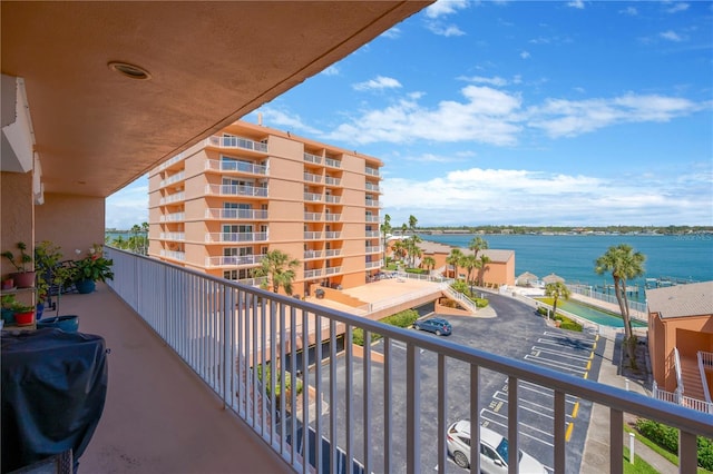 balcony with a water view and grilling area