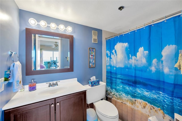 full bathroom featuring visible vents, toilet, vanity, and shower / bath combo with shower curtain