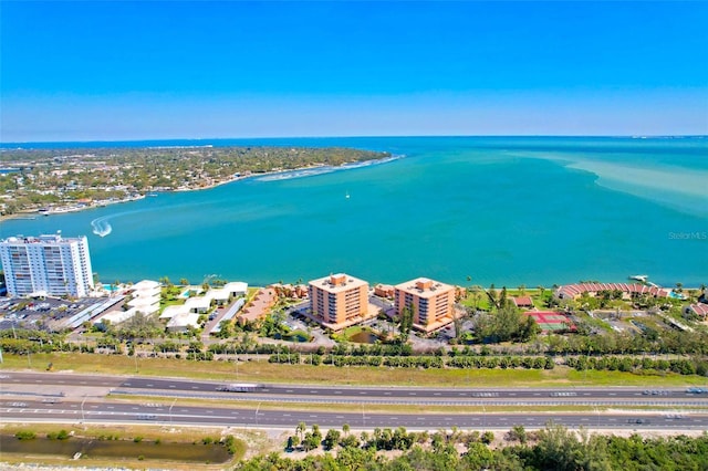 birds eye view of property with a view of city and a water view