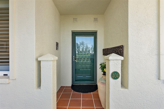 property entrance featuring stucco siding