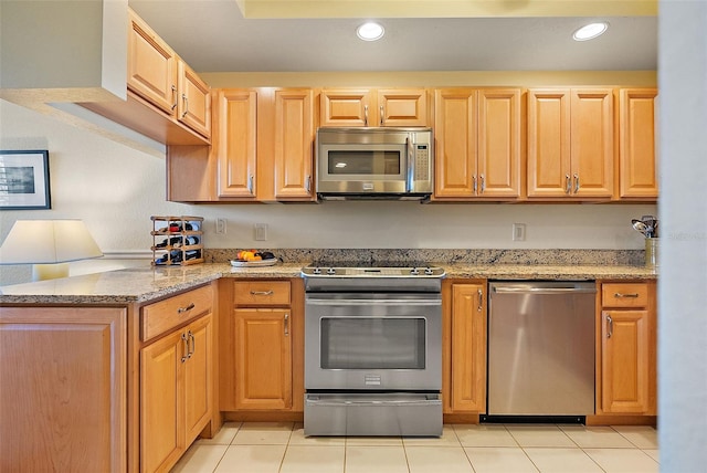 kitchen featuring light tile patterned floors, recessed lighting, stainless steel appliances, and light stone countertops