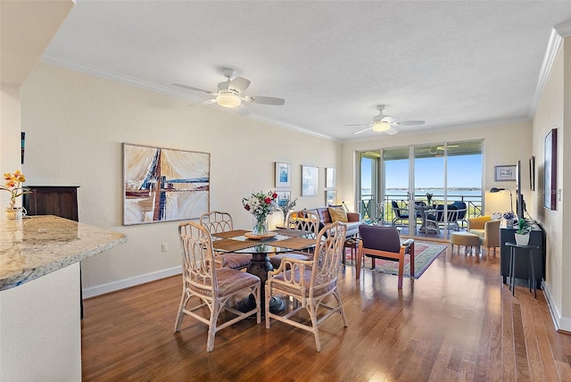 dining area with a ceiling fan, wood finished floors, baseboards, and ornamental molding