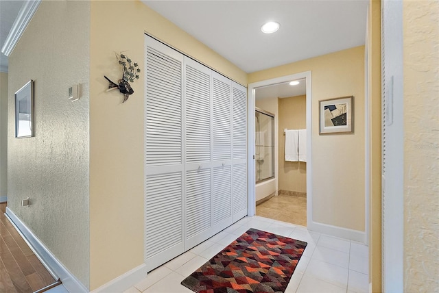 hallway with tile patterned floors, recessed lighting, and baseboards