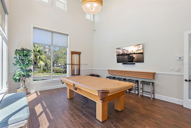 rec room with dark wood-type flooring, a high ceiling, billiards, and baseboards