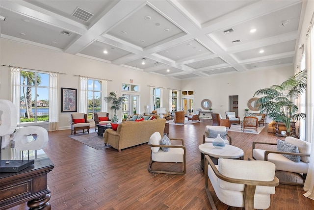 living area featuring beam ceiling, coffered ceiling, and wood finished floors