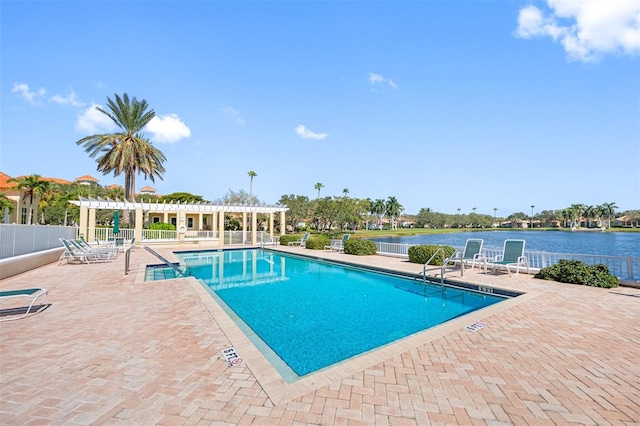 pool featuring a pergola, a water view, a patio, and fence