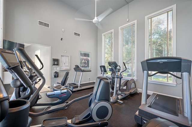 gym with baseboards, visible vents, and ceiling fan