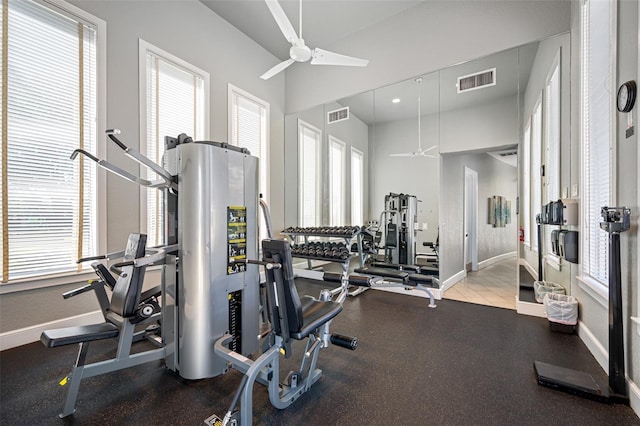 workout area featuring visible vents, baseboards, and a ceiling fan