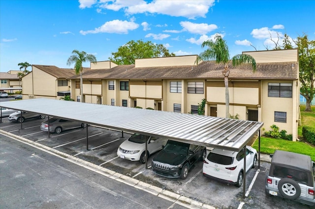 partially covered parking lot featuring a residential view