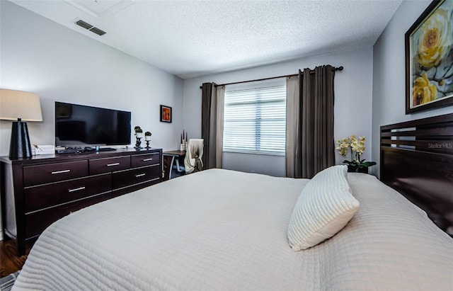 bedroom with visible vents and a textured ceiling