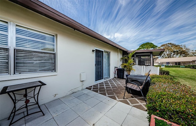 view of patio / terrace featuring a sunroom