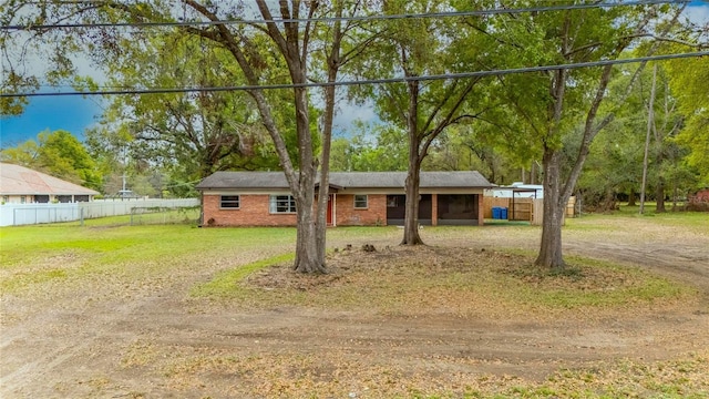 single story home with a front lawn, fence, and brick siding