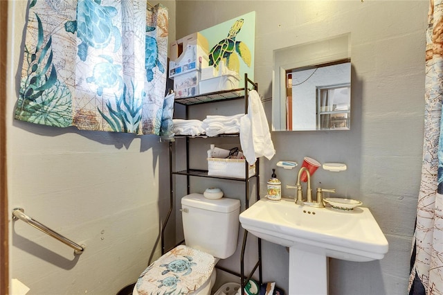 bathroom with toilet and a sink