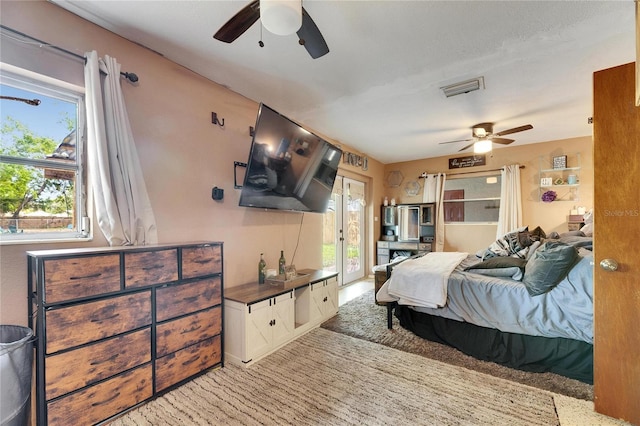 bedroom with visible vents, a ceiling fan, and access to outside