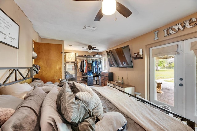 bedroom featuring a closet, visible vents, a ceiling fan, and access to outside