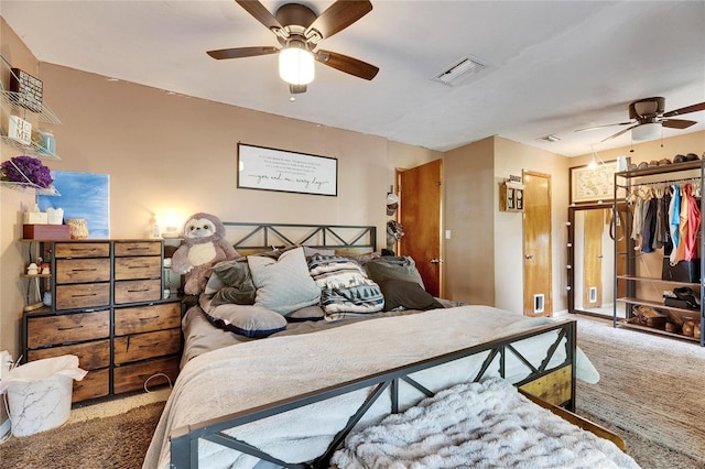 bedroom featuring visible vents, a ceiling fan, and carpet floors