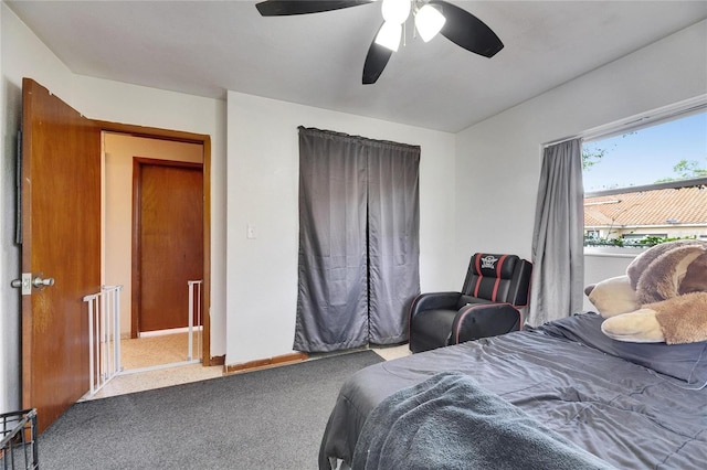 bedroom with baseboards, ceiling fan, and carpet floors