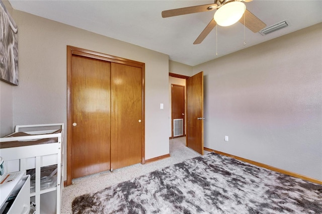 bedroom featuring a closet, baseboards, visible vents, and carpet floors