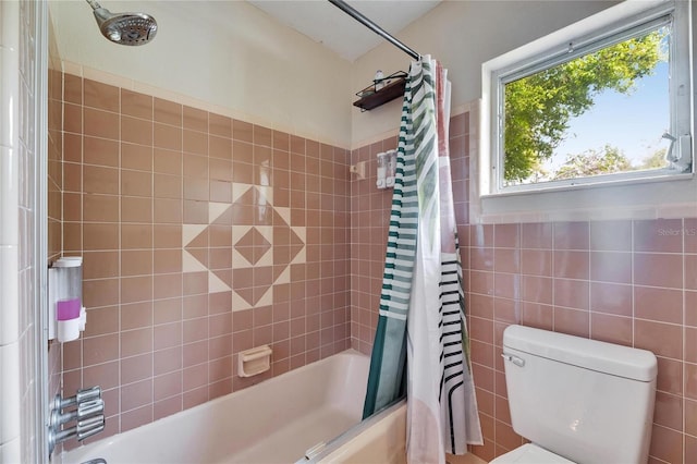 bathroom featuring tile walls, toilet, and shower / bath combo with shower curtain