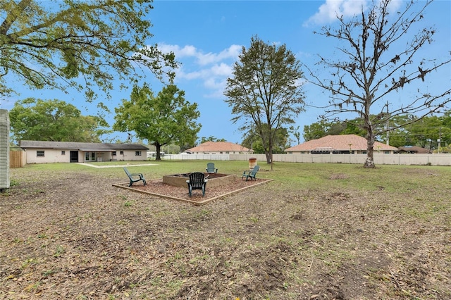 view of yard with a fire pit and a fenced backyard