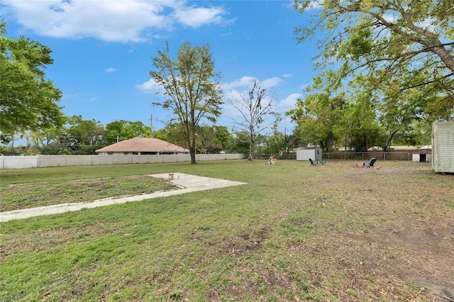 view of yard featuring an outdoor structure and fence