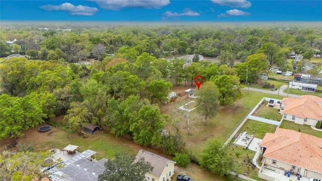 birds eye view of property with a wooded view