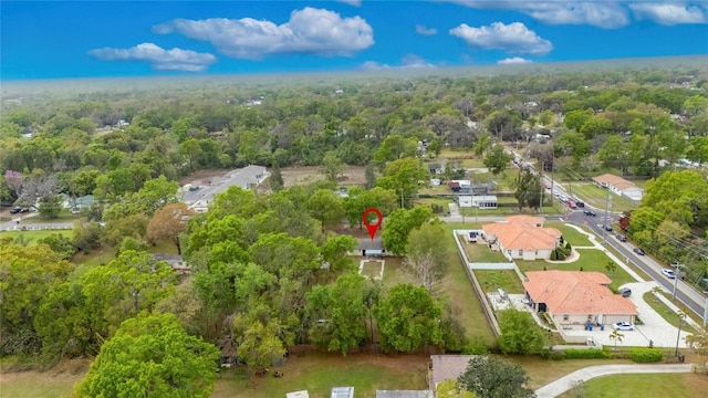 birds eye view of property featuring a view of trees