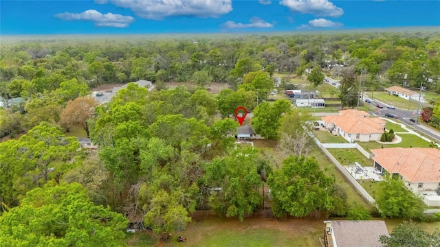 bird's eye view featuring a forest view and a residential view